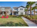 Two-story house with a front yard, walkway, and palm trees at 13384 Leggett Aly, Orlando, FL 32827