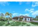 Home showcasing a three-car garage and manicured landscaping at 2647 Zuni Rd, St Cloud, FL 34771
