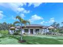 House with palm trees and lush lawn at 2647 Zuni Rd, St Cloud, FL 34771