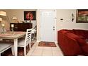 Inviting living area featuring a red sofa and front door at 2740 Maitland Crossing Way # 1, Orlando, FL 32810