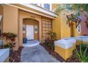 Front entry of townhome with walkway and landscaping at 4706 Vero Beach Pl, Kissimmee, FL 34746