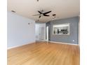 Open living area with kitchen pass-through and wood flooring at 4881 Cypress Woods Dr # 3309, Orlando, FL 32811