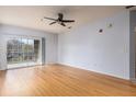 Bright living room featuring hardwood floors and sliding doors to balcony at 4881 Cypress Woods Dr # 3309, Orlando, FL 32811