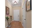 Bright entryway with tile flooring and glass-top accent table at 8426 Chamberlain Pl, Oviedo, FL 32765