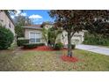 House exterior featuring a two-car garage and manicured lawn at 10952 Arbor View Blvd, Orlando, FL 32825