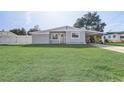Newly renovated gray house with green lawn at 1108 Evangeline Ave, Orlando, FL 32809