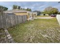 House side yard with wooden fence and grass at 1208 Honey Rd, Apopka, FL 32712