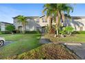 Front view of a two-story townhome with a walkway at 13312 Summerton Dr, Orlando, FL 32824