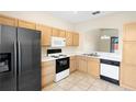 Galley kitchen with wood cabinets and appliances at 13312 Summerton Dr, Orlando, FL 32824