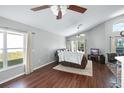 Spacious living room with hardwood floors, large windows, and a view of the backyard at 142 Santana Pl, Davenport, FL 33897