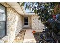 Front entry with stone facade and walkway leading to the front door at 1429 Royal Palm Dr, Edgewater, FL 32132