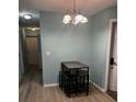 Dining area with a table and chairs, hardwood floors, and a chandelier at 1526 Providence Rd, Lakeland, FL 33805