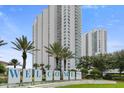 Condo building entrance with welcome sign and landscaping at 241 Riverside Drive # 409, Daytona Beach, FL 32117