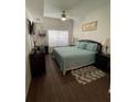 Spacious bedroom with large bed, wood floors, and ceiling fan at 2600 Lodi Cir # 101, Kissimmee, FL 34746