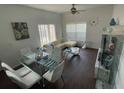 Bright living room features a glass dining table and comfy seating at 2600 Lodi Cir # 101, Kissimmee, FL 34746