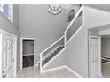 Modern staircase with metal railing in a neutral-toned entryway at 2718 Se 45Th Ave, Ocala, FL 34480