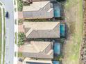 Three houses with pools and tile roofs in a community at 5437 Misty Oak Cir, Davenport, FL 33837