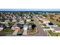 Aerial view of house and neighborhood, showcasing a lake nearby at 6163 Forest Ridge Way, Winter Haven, FL 33881