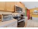 Kitchen features stainless steel appliances and light wood cabinets at 7403 Glen Oaks Way # 82, Winter Park, FL 32792
