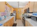 Bright kitchen with light wood cabinets and stainless steel appliances at 7403 Glen Oaks Way # 82, Winter Park, FL 32792