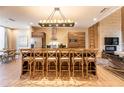 Modern kitchen with a large island, barstool seating, sleek appliances, and an open layout at 7535 Brooklyn Dr, Kissimmee, FL 34747