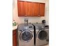 Laundry room with washer, dryer, and cabinets at 8749 The Esplanade # 29, Orlando, FL 32836