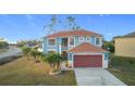 Two-story house, light blue exterior, brown roof and garage door at 1001 Dampierre Ct, Kissimmee, FL 34759