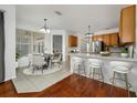 Kitchen features wood cabinets, breakfast bar, and dining area at 13442 Old Dock Rd, Orlando, FL 32828