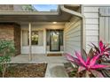 Front door entry with a welcome mat and tropical plants at 1404 N Cove Blvd, Longwood, FL 32750