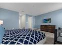 Spacious main bedroom with a large bed, dresser, and TV at 1564 Flange Dr, Davenport, FL 33896
