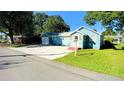 Blue house with a yard, driveway and garage at 1632 Gar St, St Cloud, FL 34771