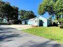 Blue house with a yard, driveway and garage at 1632 Gar St, St Cloud, FL 34771