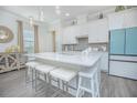 Modern kitchen with white cabinets, quartz countertops, and a large island at 1987 Key Bay Trl, Kissimmee, FL 34747