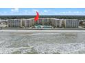 Oceanfront condominium complex featuring a swimming pool and private beach access at 2401 S Atlantic Ave # C306, New Smyrna Beach, FL 32169
