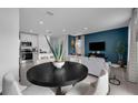 Modern dining area with black round table and gray chairs at 3330 Thicket St, Tavares, FL 32778