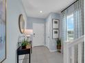 Bright entryway with tile flooring, a console table, and staircase at 3332 Thicket St, Tavares, FL 32778