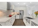 Bright kitchen with white cabinets, quartz countertops, and a farmhouse sink at 433 Carolina Ave, Winter Park, FL 32789