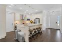 Open concept kitchen with island seating and dark hardwood floors at 433 Carolina Ave, Winter Park, FL 32789