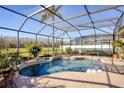 Relaxing screened pool area with fountain and lush landscaping at 437 Prestwick Dr, Davenport, FL 33897