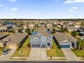 Two-story house with solar panels, neighborhood view, and a two-car garage at 4538 Cortland Dr, Davenport, FL 33837