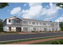 Row of townhouses with gray and blue siding, stone accents, and two-car garages at 5106 Rain Shadow Dr, Saint Cloud, FL 34772