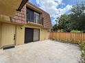 Townhouse exterior showcasing a cozy patio, neutral color scheme, and a secure fenced yard at 5341 Bamboo Ct # 418, Orlando, FL 32811