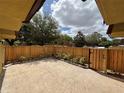 Serene patio with private wooden fence offers seclusion, landscaping, and space for outdoor enjoyment at 5341 Bamboo Ct # 418, Orlando, FL 32811