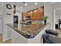 Modern kitchen with granite countertops and wood cabinets at 914 Charo Pkwy # 113, Davenport, FL 33897
