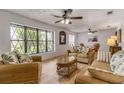 Living room with wicker furniture and large windows at 110 Dianne Dr, Ormond Beach, FL 32176