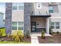 Stylish front entrance with modern door and stone accents at 1176 Challenge Dr, Davenport, FL 33896