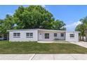 White single story house with green lawn and driveway at 124 Mercado Ave, Orlando, FL 32807