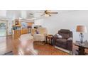 Living room with tile floors, a recliner, and view into kitchen at 137 N Nowell St, Orlando, FL 32835