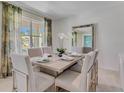 Formal dining room with a light gray table and seating for six at 1507 Aurora Ridge Dr, Zellwood, FL 32798