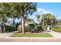 Charming house exterior with mature trees and a brick driveway at 1611 Walnut Ave, Winter Park, FL 32789